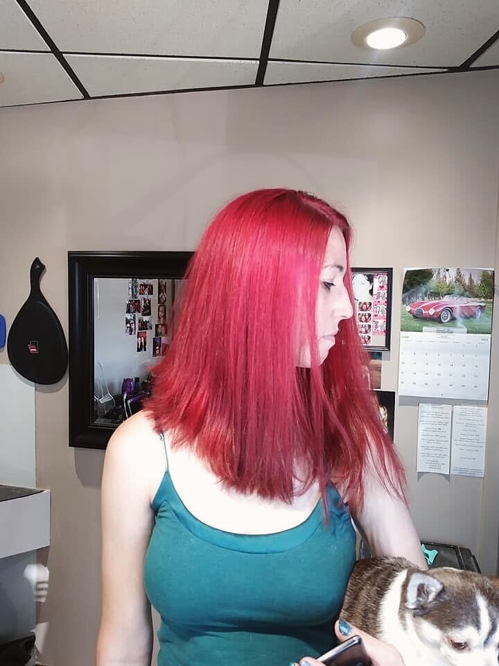 Vivid red all-over hair color freshly finished at Blown Away Salon in Louisville